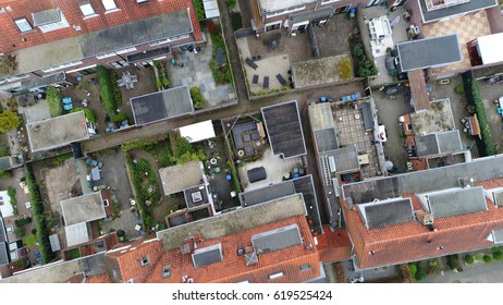 Aerial Top Down View Flying Over City Showing Neighborhood Family Houses Gardens