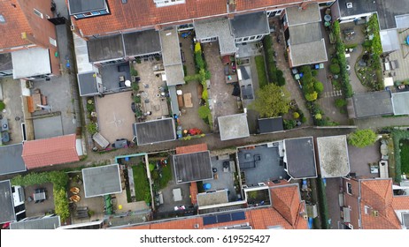 Aerial Top Down View Flying Over City Showing Neighborhood Family Houses Real Estate With Orange Red Roofs And Gardens