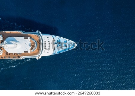 Aerial top down view of a generic cruise ship sailing over blue ocean as a travel concept with copy space