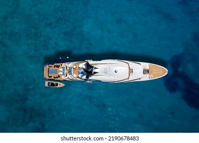 Aerial Top Down View Of A Luxury Yacht Over Turquoise Sea