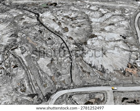 Aerial Top Down View of Mining Road Network and Grey Overburden Dumps in Coal Mine Site