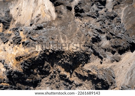 Aerial top down view of a mountain top with many steep rocky hills