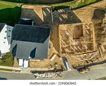 Aerial Top Down View Of Newly Built Luxury Single Family House With Roof And House Wooden Frame Under Construction In A Real Estate Development