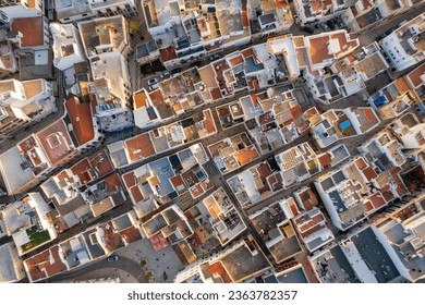 Aerial top down view of the Olhao cityscape, Ria Formosa at the sunrise, Algarve region, Portugal. Typical Portuguese architecture of Olhao town with narrow street - Powered by Shutterstock