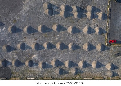 Aerial top down view on a piles of sand. Round shape. Construction material storage.