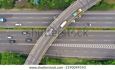 Aerial top down view on massive multi-level interchange on Jakarta city on a sunny summer day with light traffic