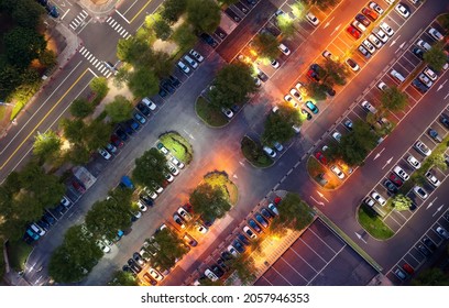 Aerial Top Down View Over A Parking Lot  At Twilight As The Evening Lights Come On With Street Lamps Lighted-up At Night In Kaohsiung City, Taiwan, Asia