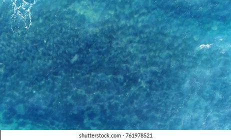 Aerial Top Down View Photo Of Azure Blue Ocean Waves Showing Beautiful Bright And Deep Blue Color From Sea Reef Shallow Water Near Tropical Island Popular Tourist Destination For Summer Vacation