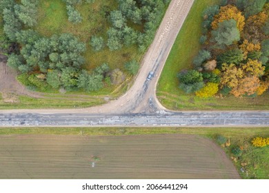 Aerial Top Down View Of Road Interchange Or Intersection With Single Car Driving