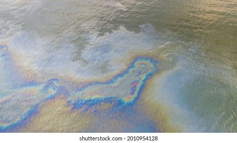 Aerial Top Down View To The Sea Surface With The Rainbow-colored Oil Spill Pattern