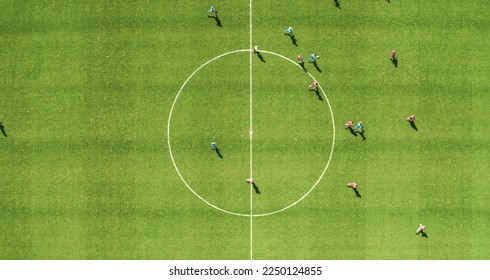 Aerial Top Down View of Soccer Football Field and Two Professional Teams Playing. Passing, Dribbling, Attacking. Football Tournament Match, International Championship. Flyover Whole Stadium Shot.