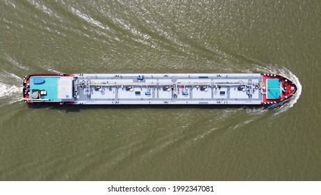 Aerial top down view of tank barge is vessel that is used to carry liquids solids and gas through waterways and rivers and across areas of ocean an essential player in energy and offshore industries