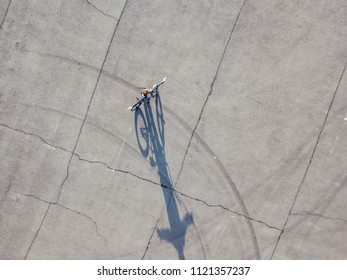 aerial top down view of teenage boy walking with bicycle isolated urban copy space - Powered by Shutterstock