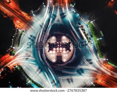 Aerial top down view of tracking cars creating light trails on a city roundabout in bucharest