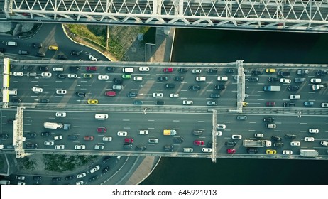 Aerial Top Down View Of Traffic Jam On A Car Bridge And Moving Train