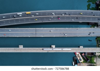 Aerial Top Down View Of Traffic Jam On A Car Bridge And Moving Train. Top View.