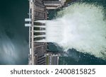 Aerial top down view of water discharge at hydroelectric power plant