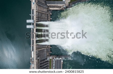 Aerial top down view of water discharge at hydroelectric power plant