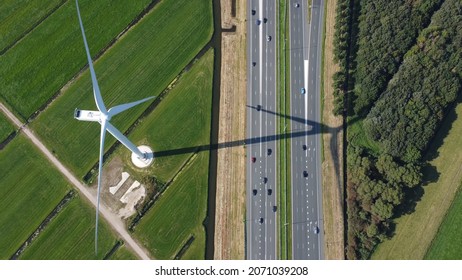 Aerial Top Down View Of Wind Turbine And Highway