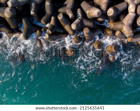Aerial top drone view of a breakwater. breakwater in the sea, a collection of concrete breakers Stock fotó © 