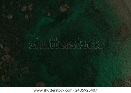 Aerial top nature view above green turquoise Adriatic sea in Albania. Beautiful young woman swimming alone in middle ocean water. girl in swimsuit bikini lying. wide panoramic view marine. summer