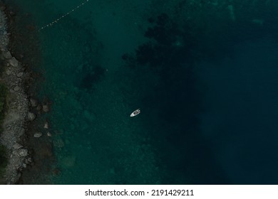 Aerial Top Nature View Drone Above Yacht Ship Turquoise Adriatic Sea In Albania. Panoramic View Marine. Summer Wallpaper. Dark Calm Water Rock Bottom. Mountain Coast Seaside. Texture Pattern Mockup