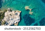 Aerial top panorama view of ocean shore huge bizarre granite rocks boulders on tropical beach with turquoise azure water. Amazing rock cliff seascape and coastline