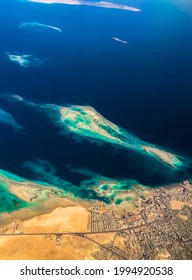 Aerial Top View From Airplane Coastline Egyptian Desert
Islands. Red Sea Sharm Al Sheikh Egypt. Amazing Shoot Bird Eye Plane Window Mountains. Travel Concept. Turbine Aircraft Engine Flying Over Ocean