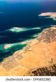 Aerial Top View From Airplane Coastline Egyptian Desert
Islands. Red Sea Sharm Al Sheikh Egypt. Amazing Shoot Bird Eye Plane Window Mountains. Travel Concept. Turbine Aircraft Engine Flying Over Ocean