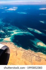 Aerial Top View From Airplane Coastline Egyptian Desert
Islands. Red Sea Sharm Al Sheikh Egypt. Amazing Shoot Bird Eye Plane Window Mountains. Travel Concept. Turbine Aircraft Engine Flying Over Ocean