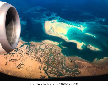 Aerial Top View From Airplane Coastline Egyptian Desert
Islands. Red Sea Sharm Al Sheikh Egypt. Amazing Shoot Bird Eye Plane Window Mountains. Travel Concept. Turbine Aircraft Engine Flying Over Ocean