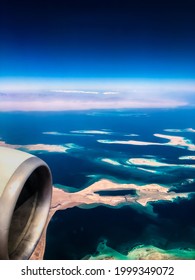 Aerial Top View From Airplane. Coastline Egyptian 
Islands. Red Sea Sharm Al Sheikh Egypt. Amazing Shoot Bird Eye Plane Window Mountains. Travel Concept. Turbine Aircraft Engine Flying Over Ocean