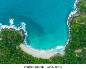 
aerial top view amazing freedom beach small white sand beach with perfect nature. 
white wave hit the rock around island. 
green forest peaceful. green sea, and clear sand landscape. Paradise beach.
 - Powered by Shutterstock