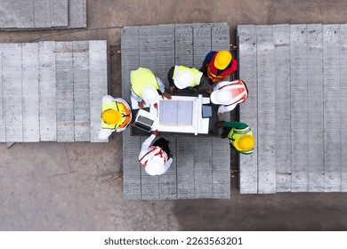 Aerial top view of architect and engineer discussing building plan at table and his blueprints on Precast concrete, Cement slab floor concrete slab stacked construction site. meeting, roof plan - Shutterstock ID 2263563201