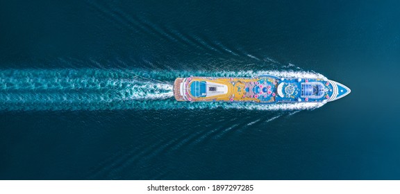 Aerial top view of beautiful white cruise running with contrail in the ocean sea, luxury cruise in the ocean sea concept tourism relax and travel on holiday vacation time.