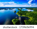 Aerial top view of blue lakes with islands and green forests in Finland. Beautiful summer landscape.