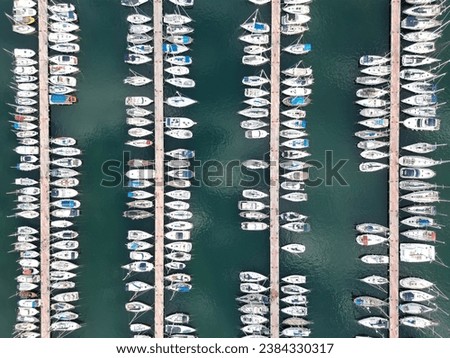 Aerial top view of boats and yachts in marina from above. Yacht parking, A marina lot, Yacht and sailboat is moored at the quay, Aerial view by drone.