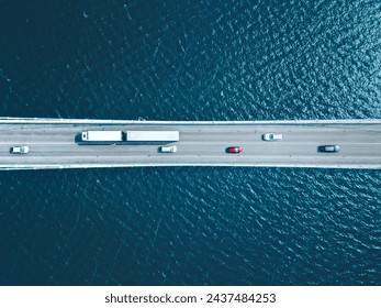 Aerial top view of bridge road with cars over lake or sea in Finland - Powered by Shutterstock