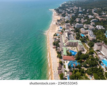 aerial top view of Bulgaria's resort during the summer season: an array of hotels, pools, and crowds of people enjoying the sea. - Shutterstock ID 2340153345
