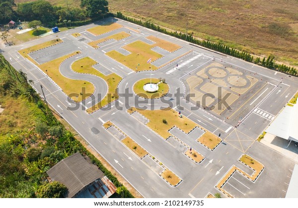 Aerial\
top view of a car driving test center with street road. Course\
field, practice vehicle school.  Map site\
design.