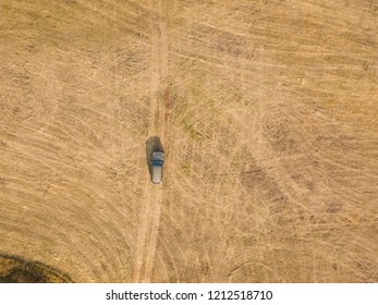 aerial top view of car isolated on summer field texture background