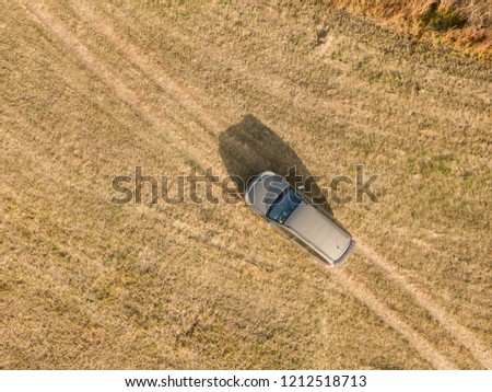 aerial top view of car isolated on summer field texture background