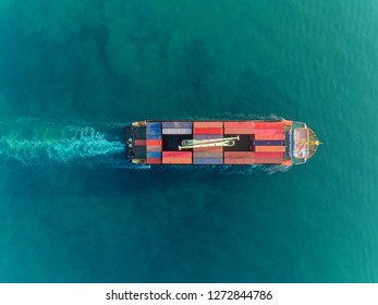 Aerial top view container ship at sea port and working crane bridge full load container for logistics import export, shipping or transportation concept.