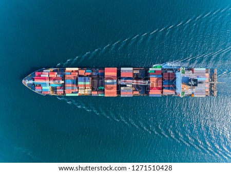 Aerial top view container ship with crane bridge for load container, logistics import export, shipping or transportation concept background.