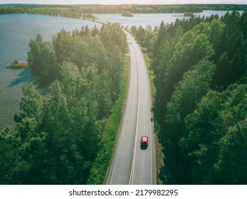 Aerial top view of country road through green woods and blue lakes in summer Finland - Shutterstock ID 2179982295