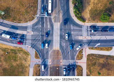 Aerial Top View Of Crossroads With Lot Of Vehicles Or Car Traffic, Modern Urban Intersections And Junctions In Midtown. Road Traffic On Crossroad Or Intersection Downtown Of European. 