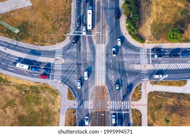 Aerial Top View Of Crossroads With Lot Of Vehicles Or Car Traffic, Modern Urban Intersections And Junctions In Midtown. Road Traffic On Crossroad Or Intersection Downtown Of European. 
