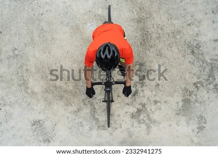 Aerial top view of Cyclist with helmet and sunglasses riding a bicycle  isolated on white background