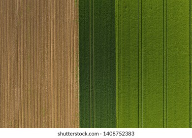 Aerial top view of a different agriculture fields in countryside on a spring day. Drone shot
