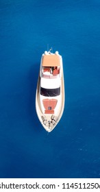 Aerial top view drone photo of luxury yacht docked in tropical turquoise bay